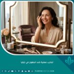امرأة تنظر في المرآة بسعادة ورضا لتفقد النتائج النهائية بعد نجاح تجربة عملية شد الجفون في تركيا.